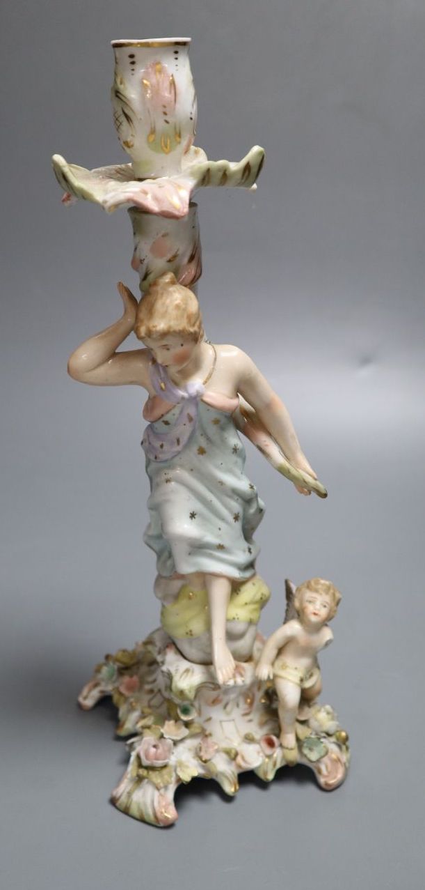 A German porcelain candlestick with lady and cherub, height 26.5cm (a.f.)